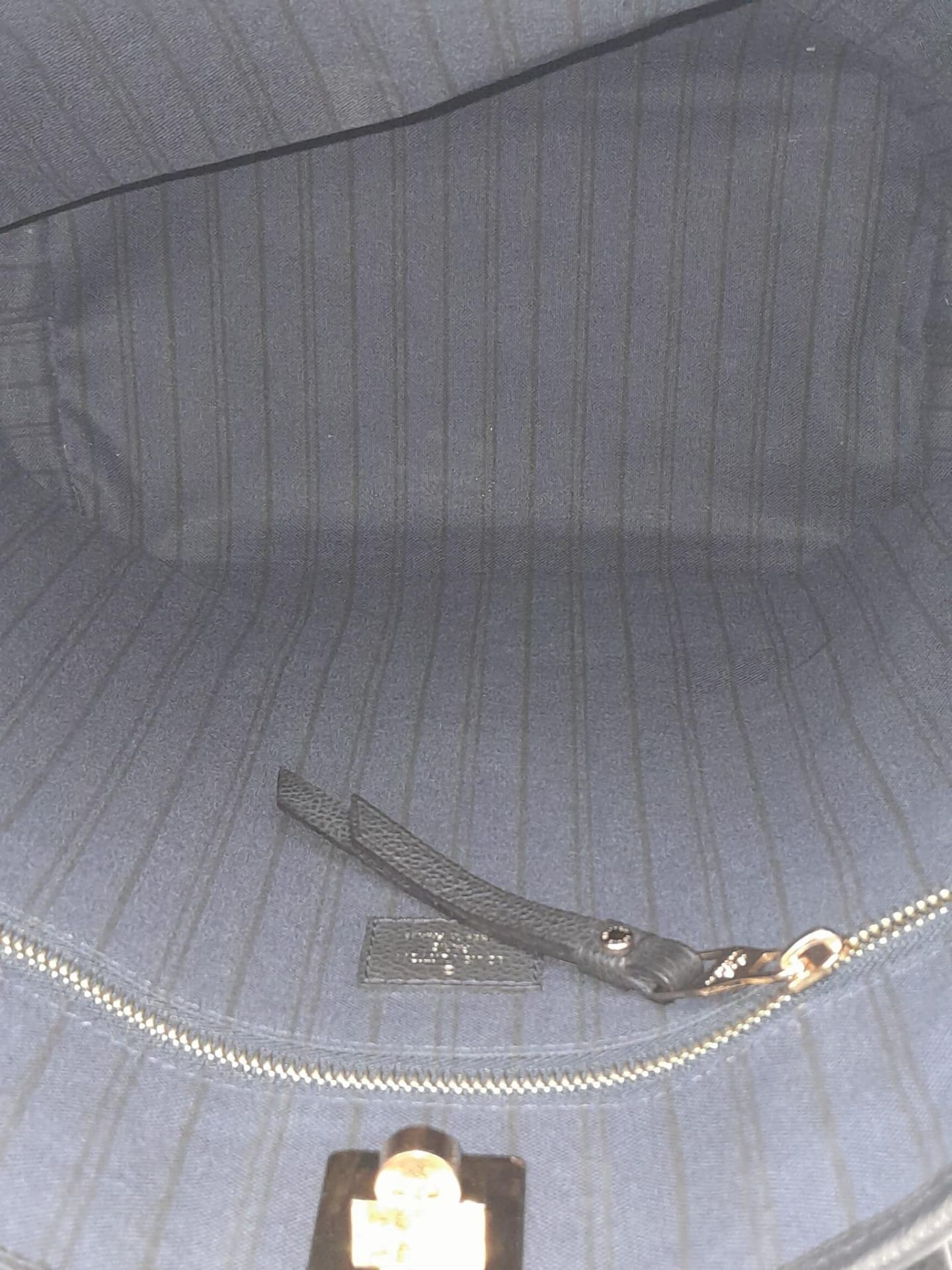 A Louis Vuitton Monogram Empreinte PM Tote Bag. Navy blue exterior with gold tone hardware. Spacious - Image 6 of 10