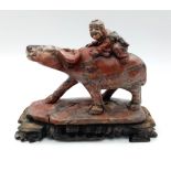 A wonderful Hardstone Chinese Antique Figure on a wooden base. Lovely red, grey and white colours in
