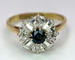An 18K Yellow Gold Fancy Floral Diamond and Sapphire Ring. A central sapphire with round diamonds