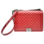 A Chanel Red 'Boy' Flap Bag. Quilted leather exterior with an aged silver-toned CC squeeze lock
