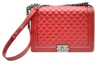 A Chanel Red 'Boy' Flap Bag. Quilted leather exterior with an aged silver-toned CC squeeze lock