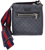 A Gucci Monogram Messenger Bag. GG grey canvas exterior wit black leather accents and zipped