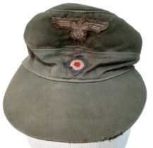 A WW2 German Africa Corps M41 Field Cap. A real “Been There” item. Small Size.