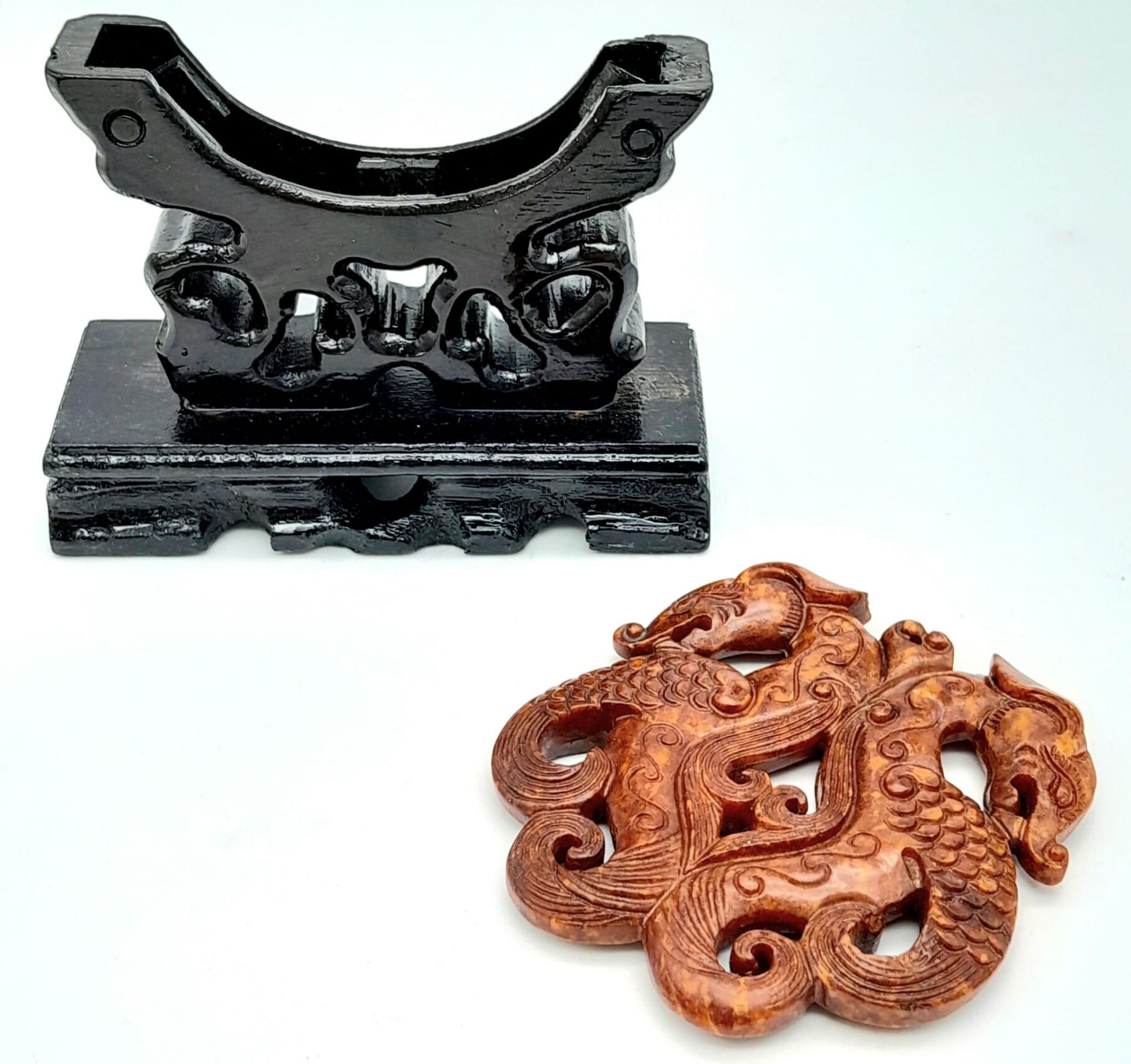 A Chinese carved reddish brown jade amulet with a fascinating, highly detailed design of two - Image 2 of 3