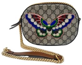 A Gucci GG Butterfly Design Crossbody Bag. Monogram canvas with brown leather surround.