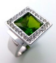 A magnificent 925 silver faceted Peridot solitaire ring with Zirconia surrounded. Total weight 8.