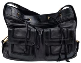 An Yves Saint Laurent Black Shoulder Bag. Leather exterior with patent leather details, gold-toned