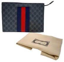 A Gucci GG Supreme Pouch Canvas Bag. Monogram exterior with blue and red stripes. Beige textile