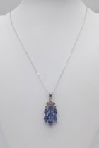 An Unworn Sterling Silver Blue Topaz and Diamond Pendant Necklace. 50cm Length Chain. Pendant