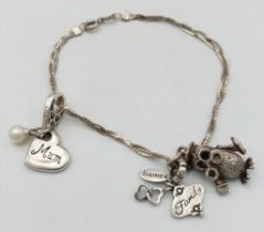 A vintage sterling silver charm bracelet. Total weight 9G. Total length 20cm. Please see photos