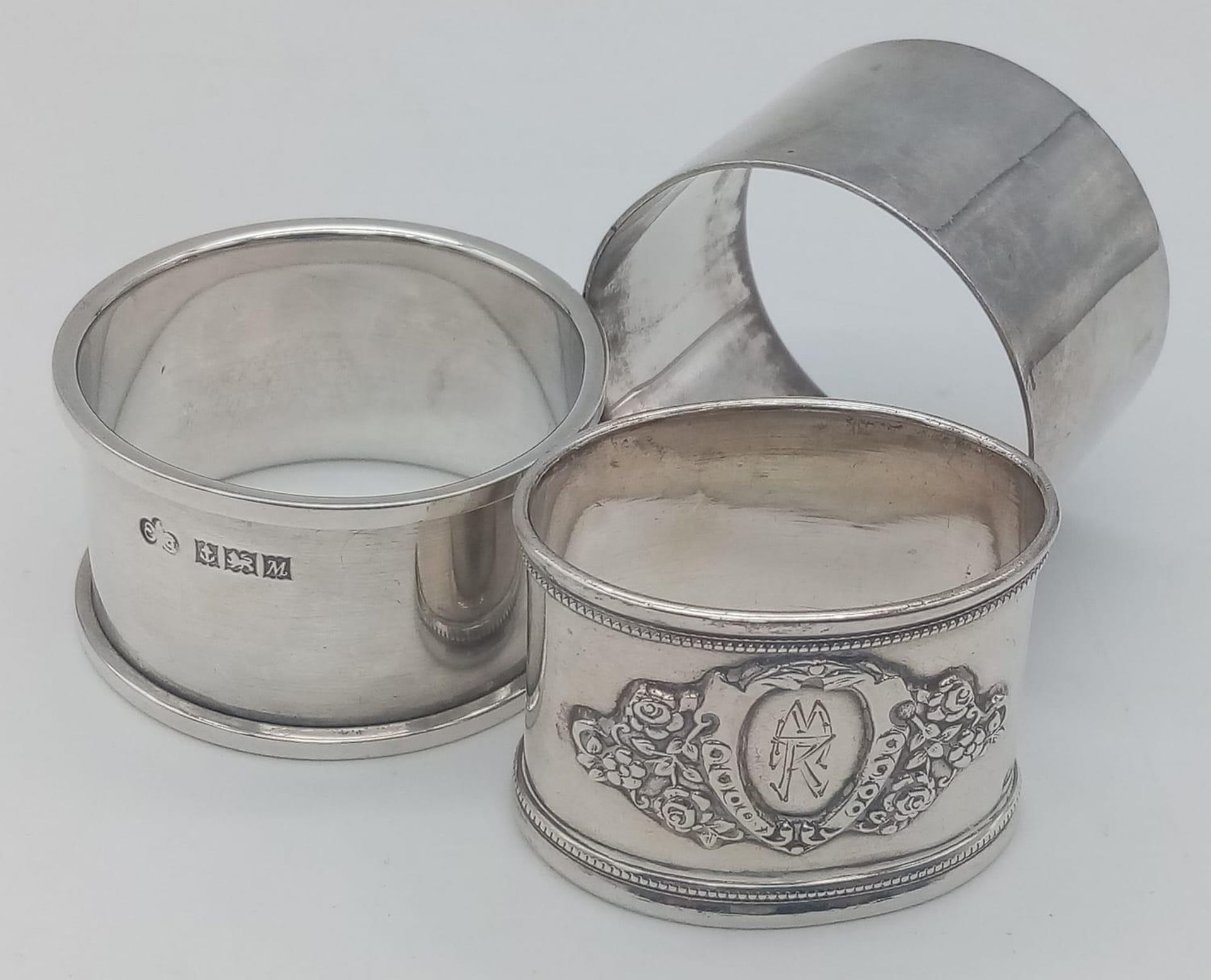 A collection of 3 vintage sterling silver napkin holders include 2X circular with full Birmingham