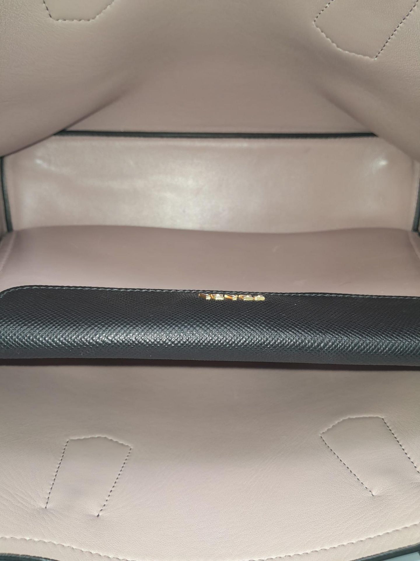 A Prada Black Leather Handbag. Textured black exterior with gold-tone hardware. Pastel pink - Image 6 of 9