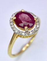 A 14K Yellow Gold Ruby and Diamond Ring. Central oval cut 1.50ct ruby with a 0.16ctw diamond