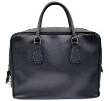 A Prada Black Briefcase. Saffiano leather exterior with two rolled handles, silver toned hardware,