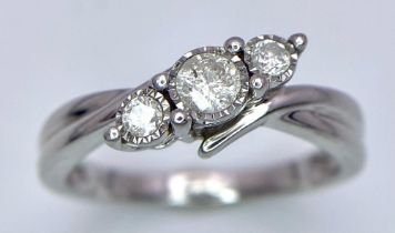 A 9K White Gold Graduated Diamond Trilogy Ring. Twist mount setting. Diamonds - 0.2ctw. Size K. 2.