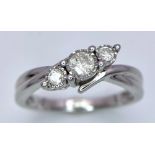 A 9K White Gold Graduated Diamond Trilogy Ring. Twist mount setting. Diamonds - 0.2ctw. Size K. 2.