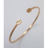 An 18K Yellow Gold Gucci Designer Cuff Bangle. Comes with a variety of plush Gucci packaging