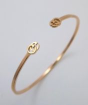 An 18K Yellow Gold Gucci Designer Cuff Bangle. Comes with a variety of plush Gucci packaging