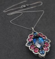 This Blue Topaz, Ruby & Diamond, Sterling Silver Pendant Necklace is a jaw-dropper. With 30cts of