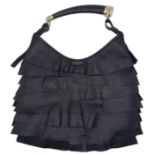 A YSL Saint-Tropez Handbag. Black leather strip exterior. Horn shaped handle. Textile interior