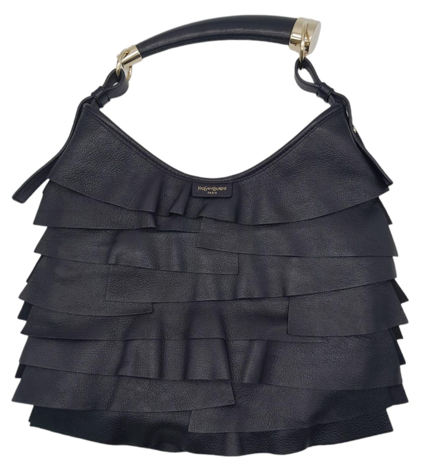 A YSL Saint-Tropez Handbag. Black leather strip exterior. Horn shaped handle. Textile interior
