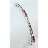 A Nine Ruby Gemstone Clip-Open Bracelet set in 925 Silver. 55mm inner diameter. Ref: CD-1115