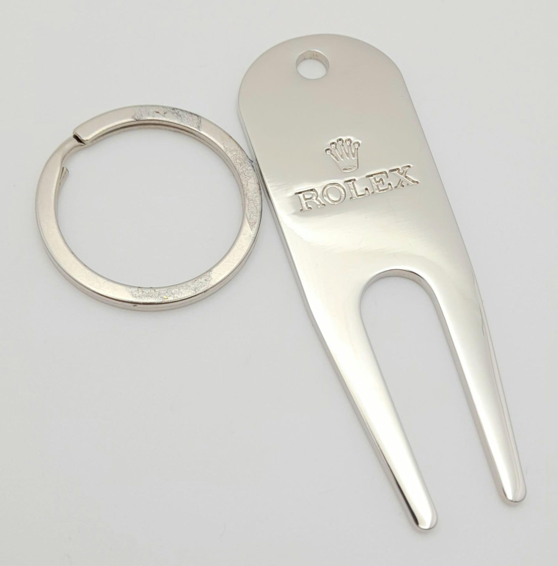 A Rolex Branded Putting Green Divot Repair Tool. Comes with a keyring attachment. In as new