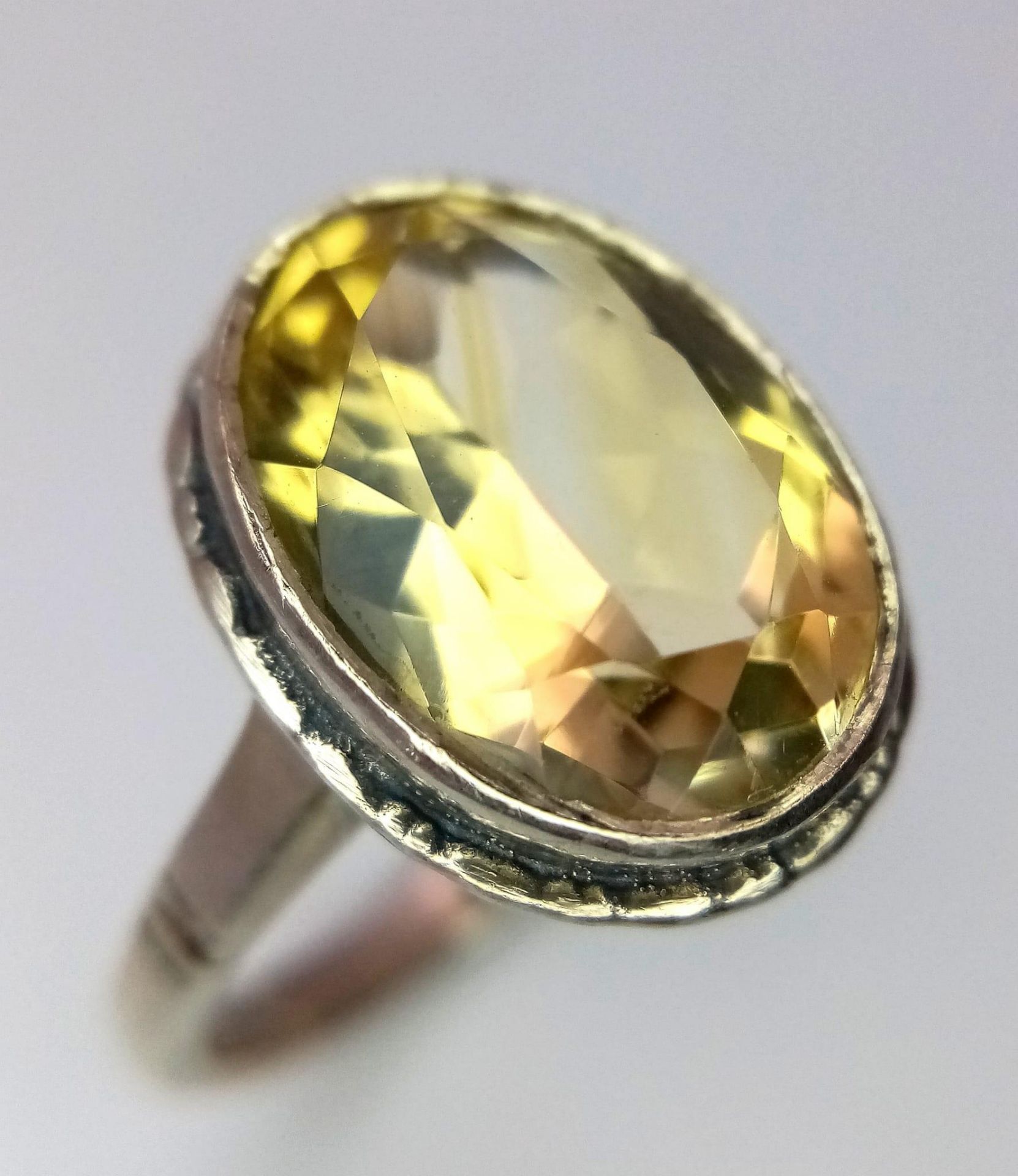 A Vintage Silver and Large Oval Cut Citrine Set Ring Size P. The Ring is set with a 1.5cm Long