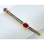A Ruby and Diamond Bracelet set in Gold Plated 925 Silver. Six oval cut rubies with multi diamond