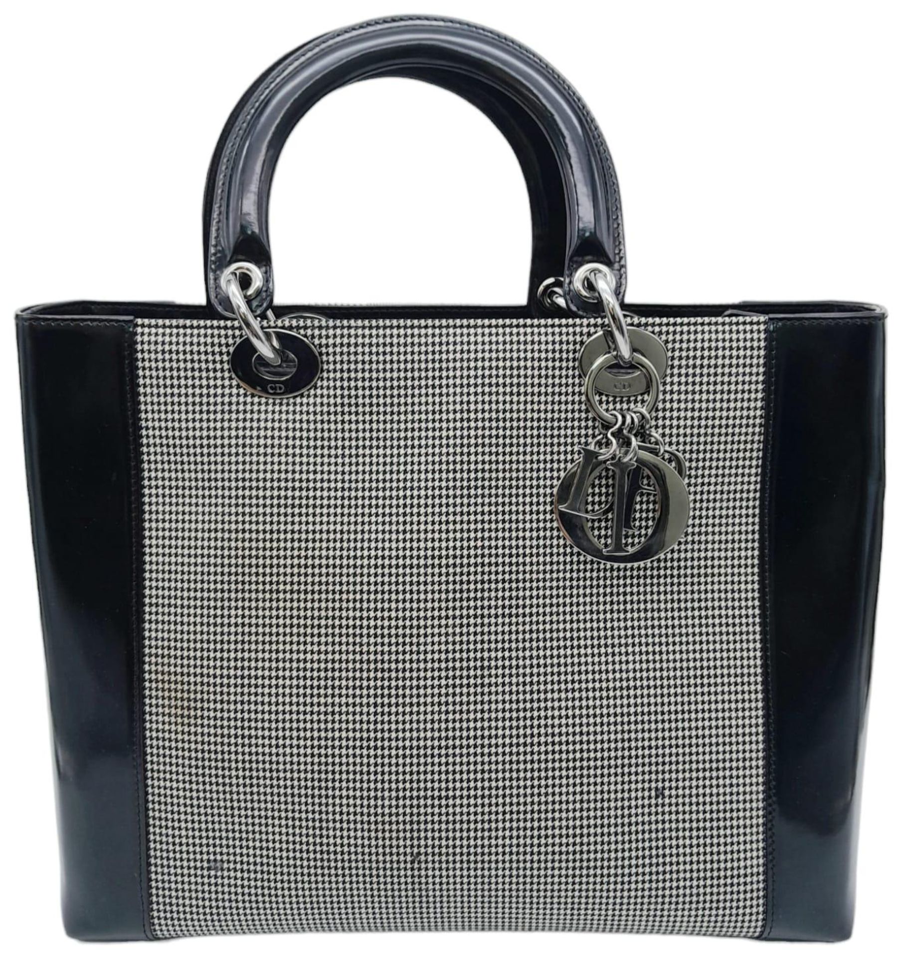 A Christian Dior - Lady Dior Bag. Canvas and black patent leather exterior. Silver tone hardware. - Image 2 of 9