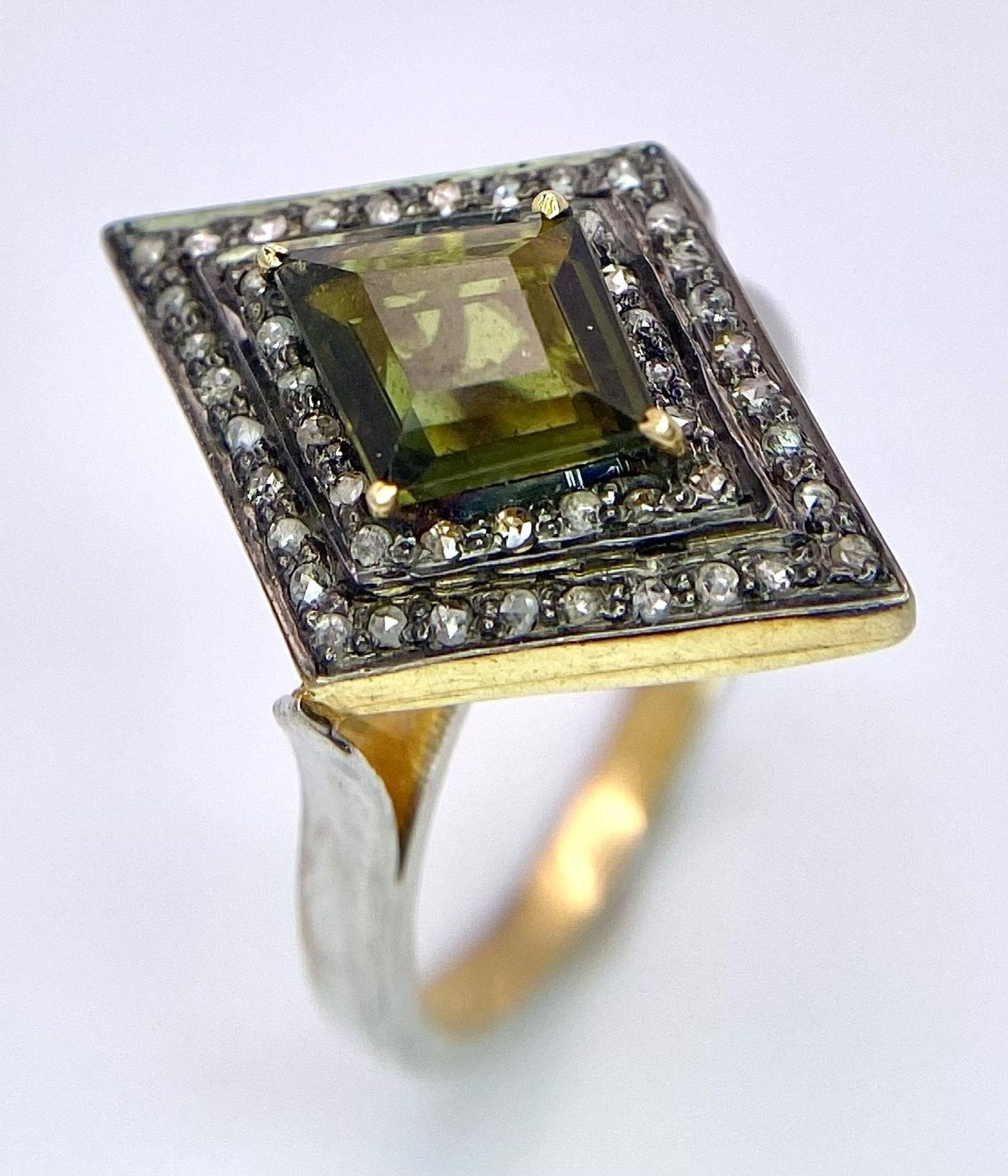 A Silver Gilt Diamond-Shaped Ring set with a Kite-Shaped Green Tourmaline and a Double Halo of