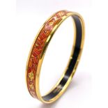 A Hermes Gilded and Enamel Bangle. 6cm inner diameter. Ref: 15686