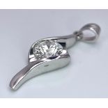An 18 K white gold drop pendant with a single brilliant round cut diamond (0.52 carats), total