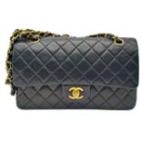 A Chanel Matelasse Chain Shoulder Flap Bag. Black Quilted lamb leather. Gold-tone hardware. CC