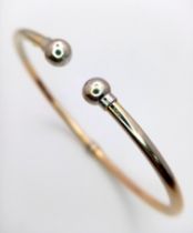 A fancy 9Ct gold adjustable torque bangle. Total weight 3.85G.