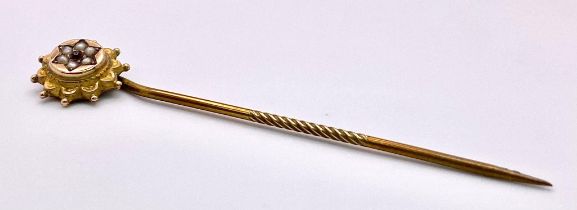 An Antique Mid-Karat Gold, Seed Pearl and Ruby Stick-Pin. 5.5cm. 0.91g total weight.