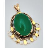 A NATURAL JADE PENDANT SET IN 9K GOLD . 4.6gms