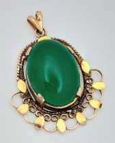 A NATURAL JADE PENDANT SET IN 9K GOLD . 4.6gms