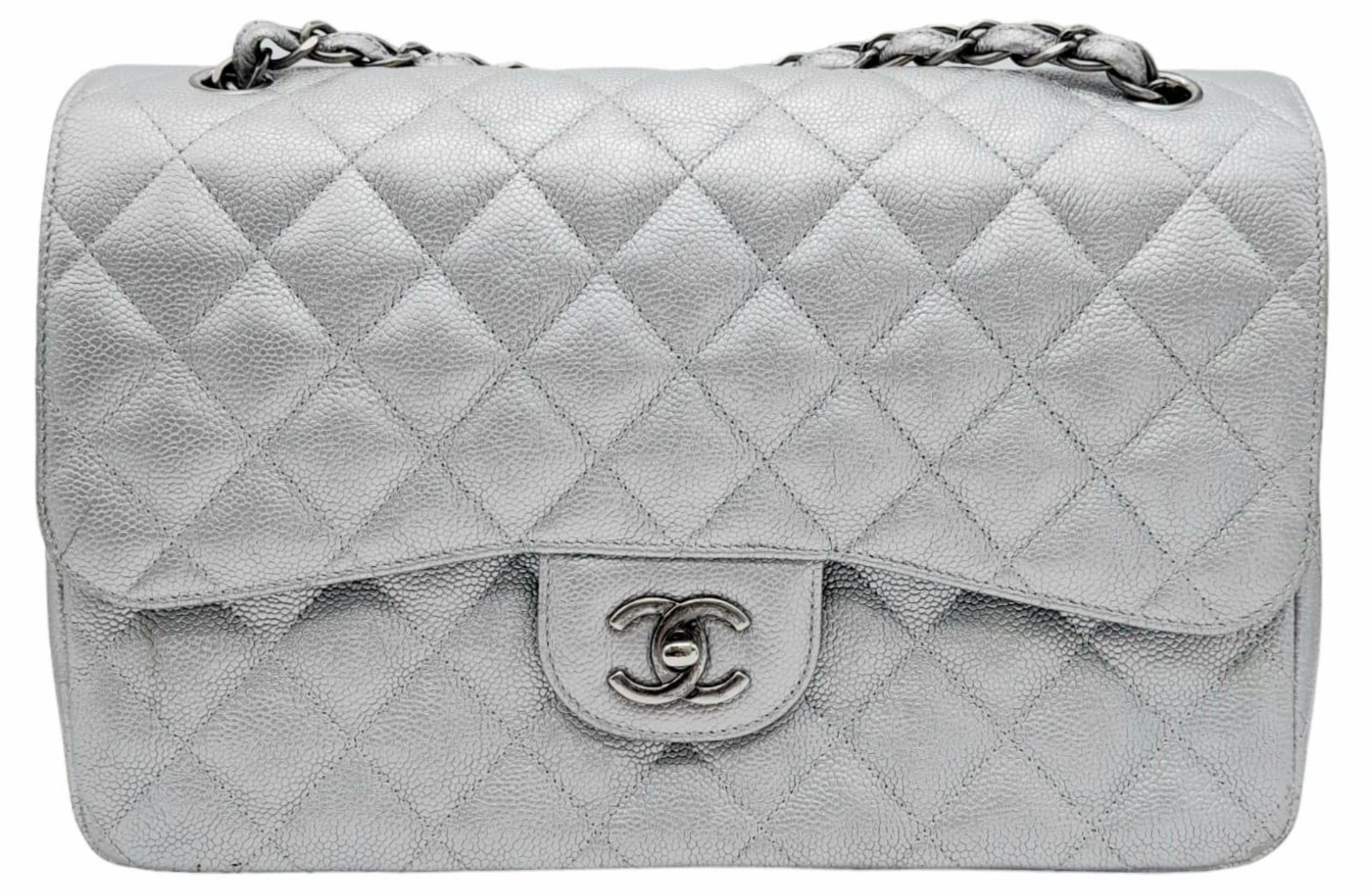 A Chanel Metallic Silver Double Flap Jumbo Bag. Quilted caviar leather. Silver tone hardware. Double