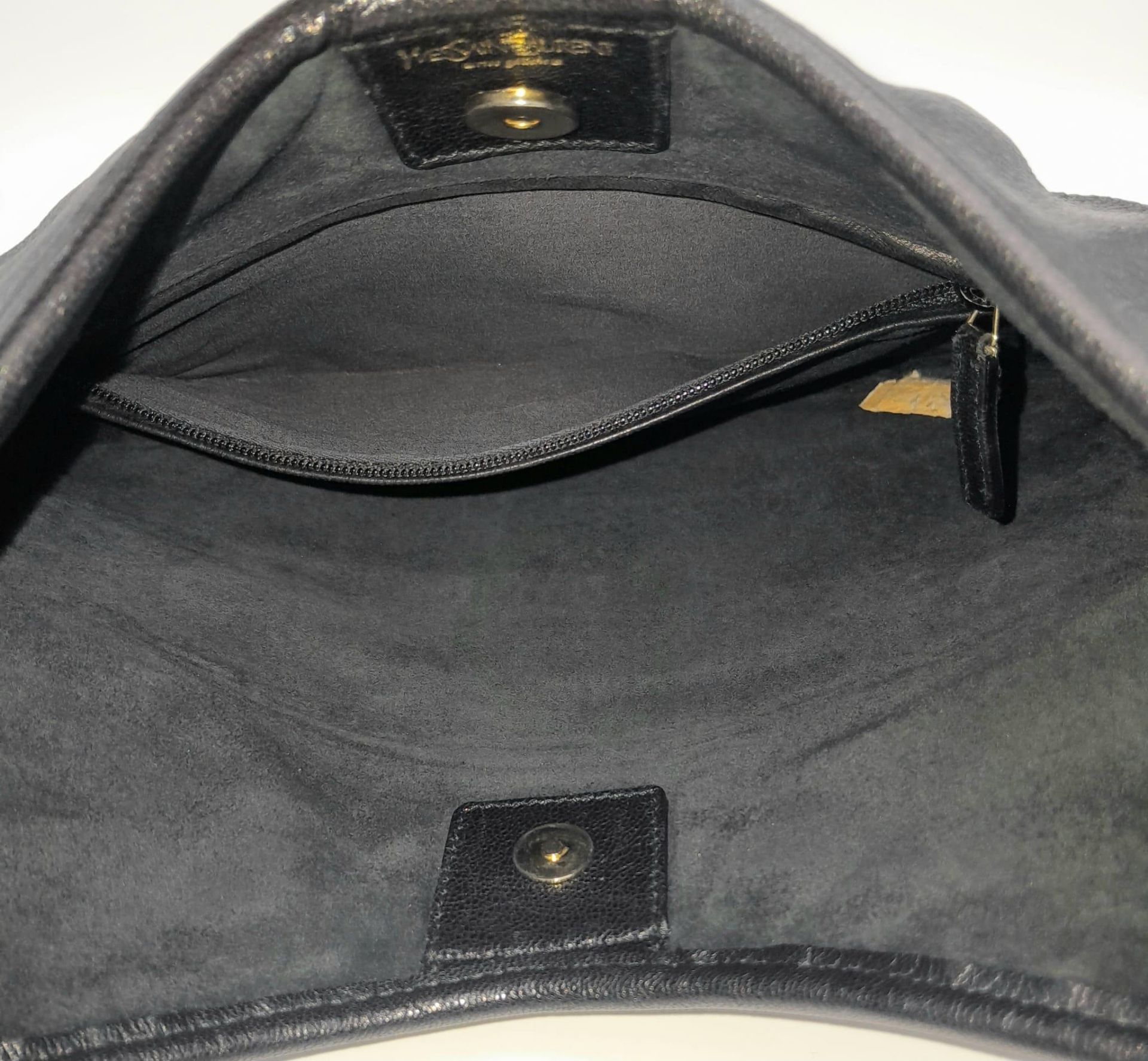 A YSL Saint-Tropez Handbag. Black leather strip exterior. Horn shaped handle. Textile interior - Image 6 of 8