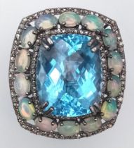 A Mesmerising Blue Topaz, Opal and Diamond Gemstone Ring. Central rectangular blue topaz 20.25ct