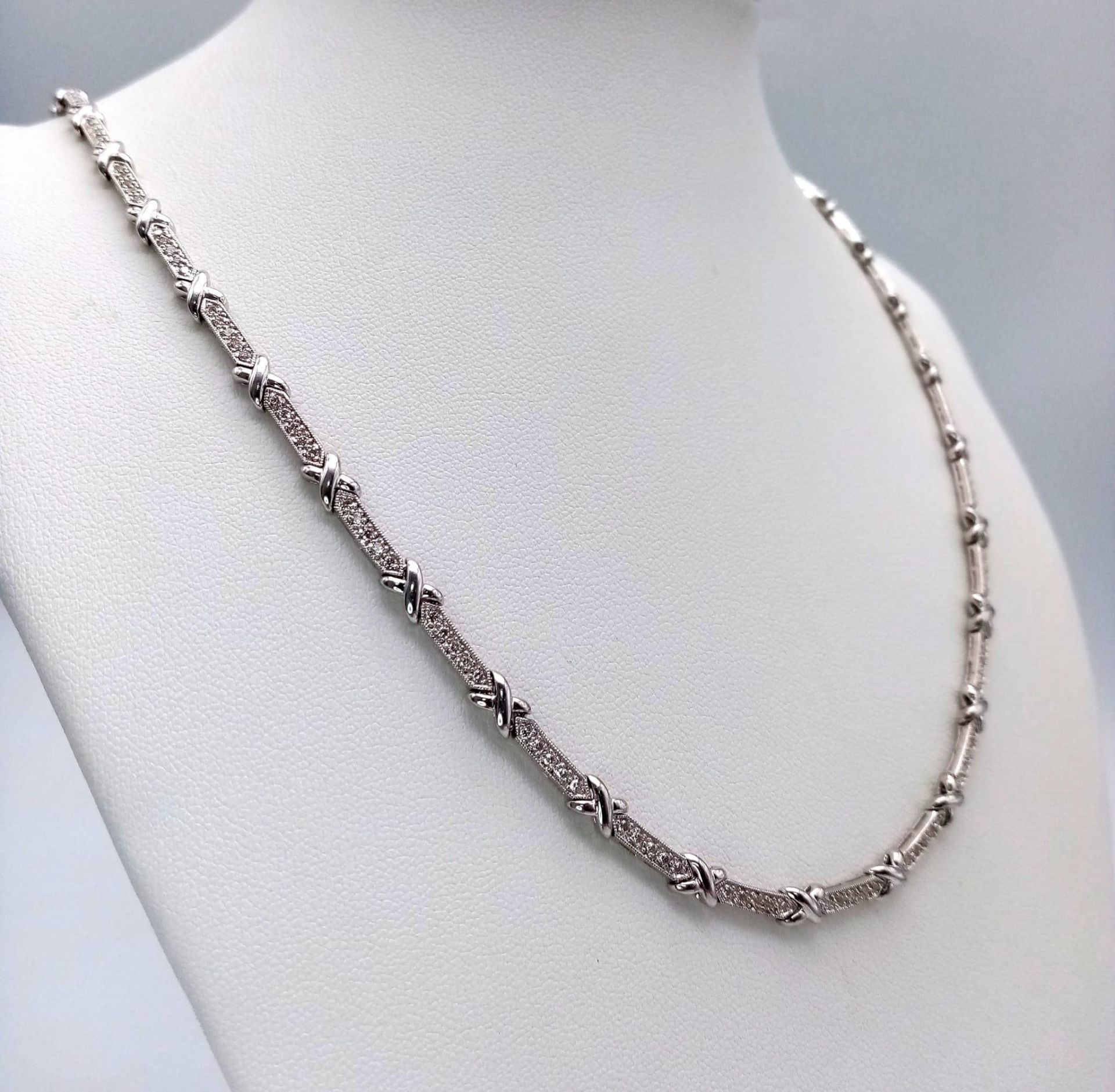 An 18K White Gold and Diamond Bar Link Necklace. 1.24ctw of diamonds. Love-knot separators. 43cm - Image 2 of 6