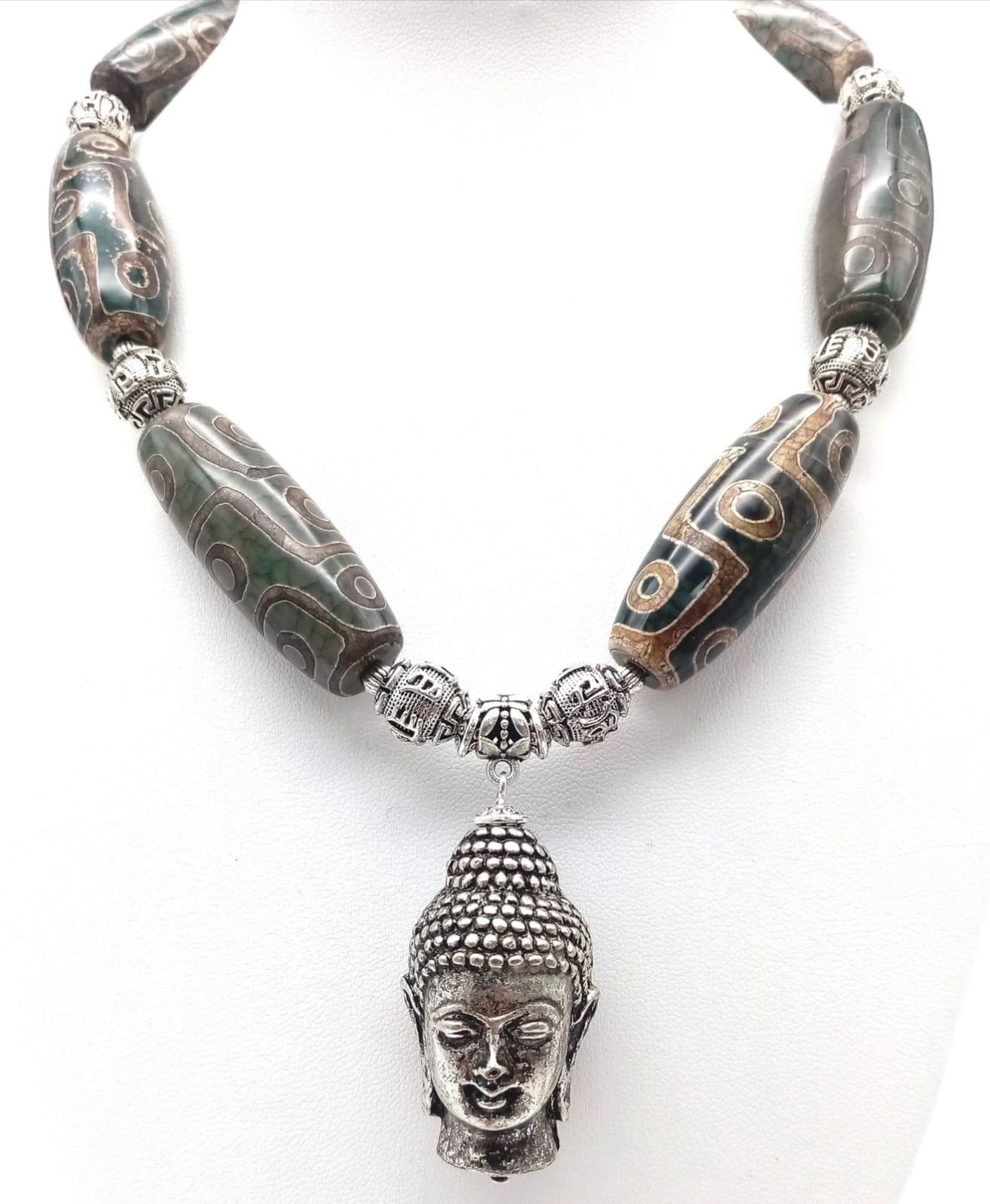 A Tibetan treasure: a nine eyed, large DZI beaded necklace and earrings set with a young Buddha head - Image 5 of 7