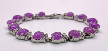 A Purple Jade Cabochon Tennis Bracelet. White stone spacers. 17cm.