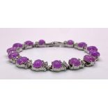 A Purple Jade Cabochon Tennis Bracelet. White stone spacers. 17cm.