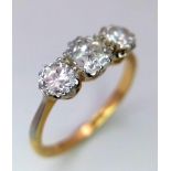 An 18 k yellow gold ring with a trilogy of brilliant round cut diamonds (1 carat min.), ring size: