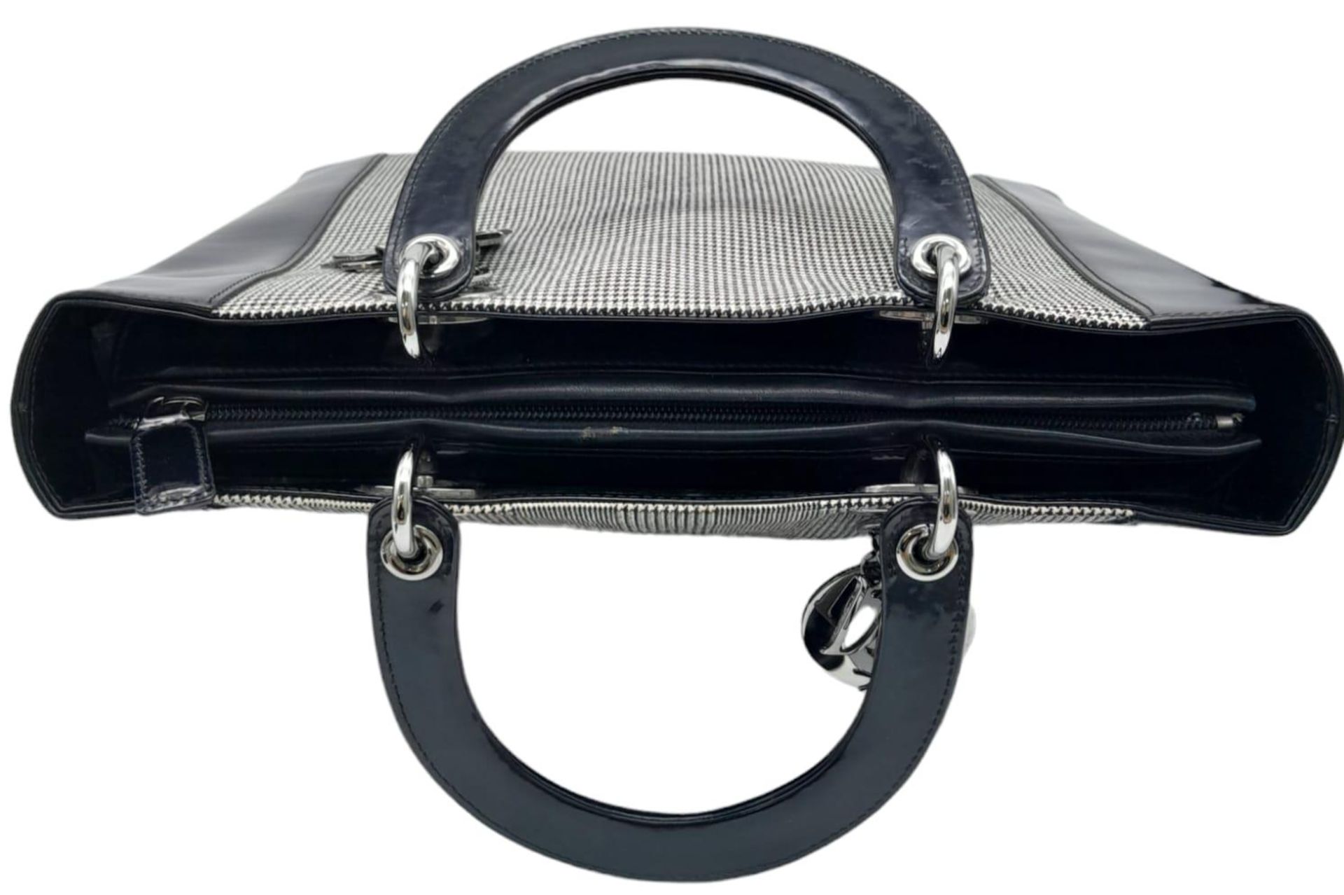 A Christian Dior - Lady Dior Bag. Canvas and black patent leather exterior. Silver tone hardware. - Image 5 of 9