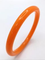 A Beautiful Orange Jade Thin Bangle. 6cm inner diameter. 7mm width.