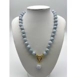 A Blue Aquamarine Bead Necklace with Drop Pendant. Gilded and white stone snap clasp. 42cm