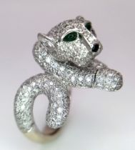 An 18K Gold and Diamond Panther Ring. An encrusted, pave set pouncing Panther with Emerald eyes